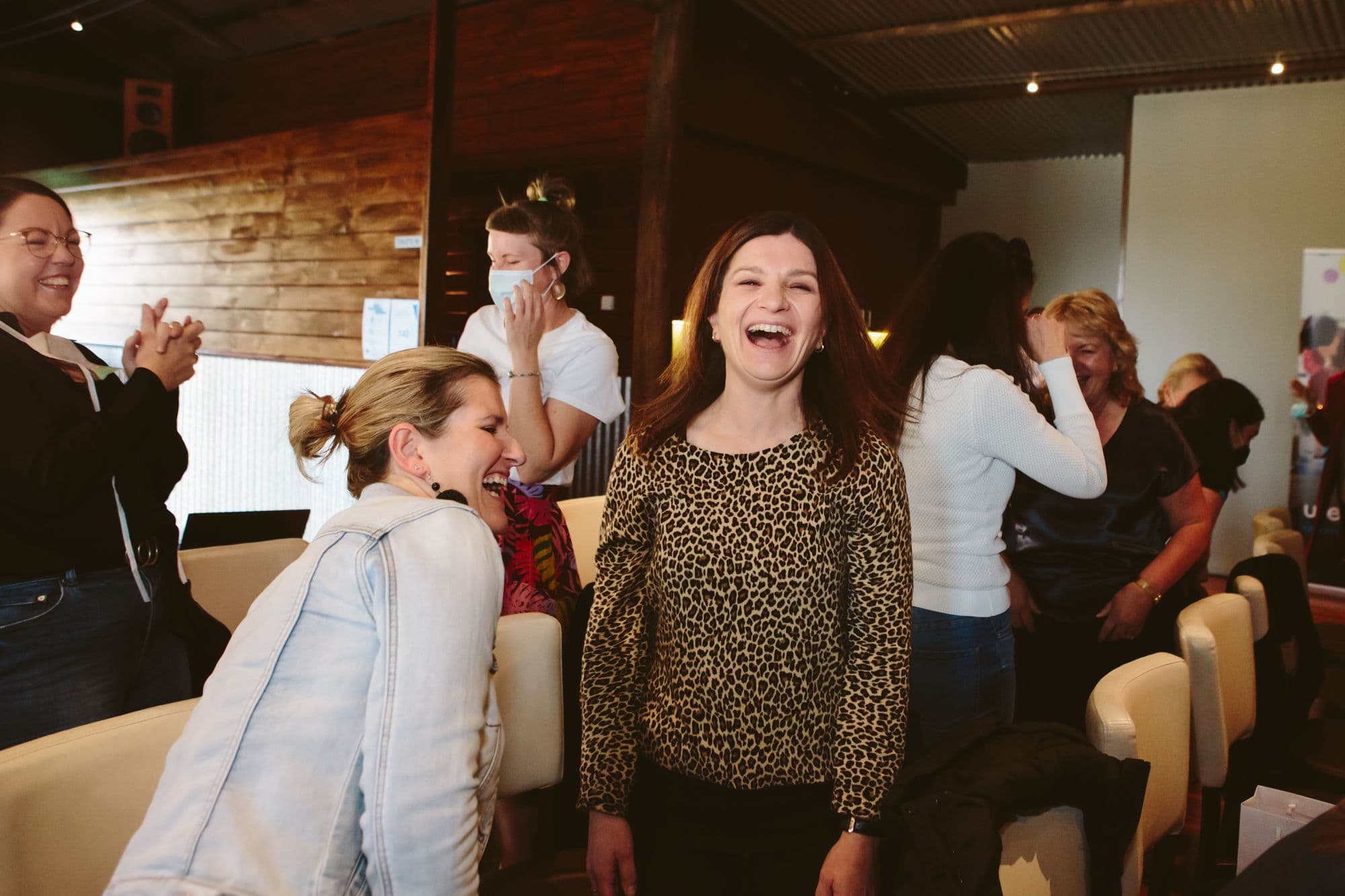 Colleagues laughing together during a Better Us session