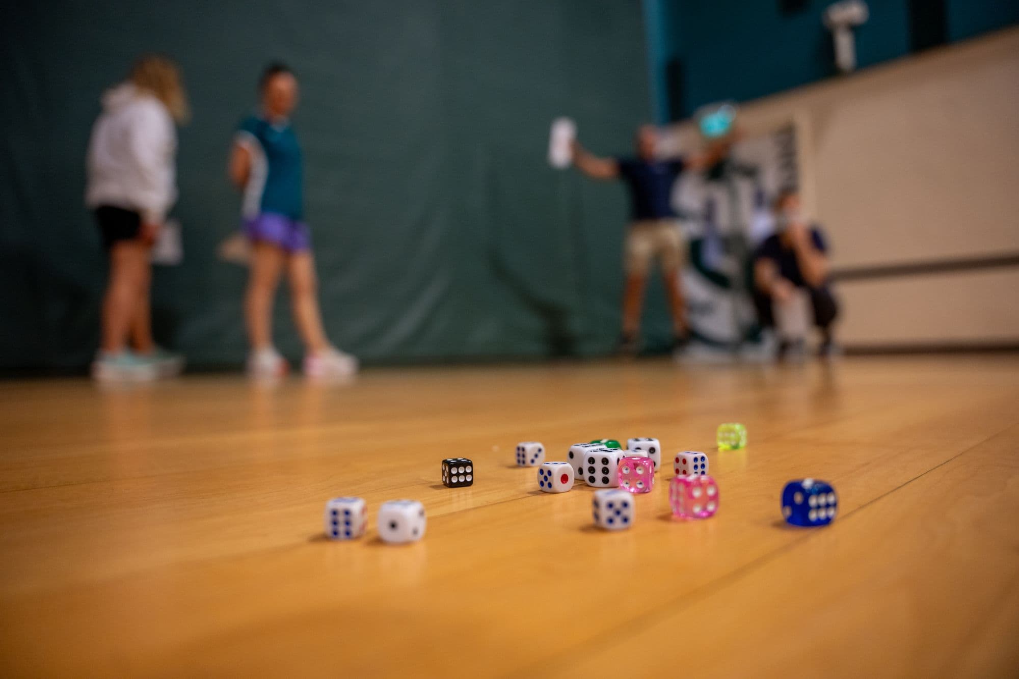 Coloured dice scattered across a floor during a game