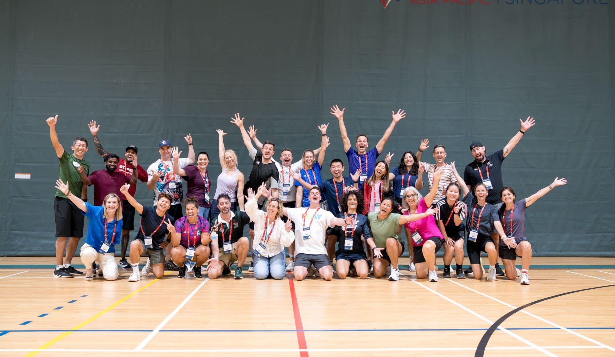 A whole group celebrating together, arms in the air