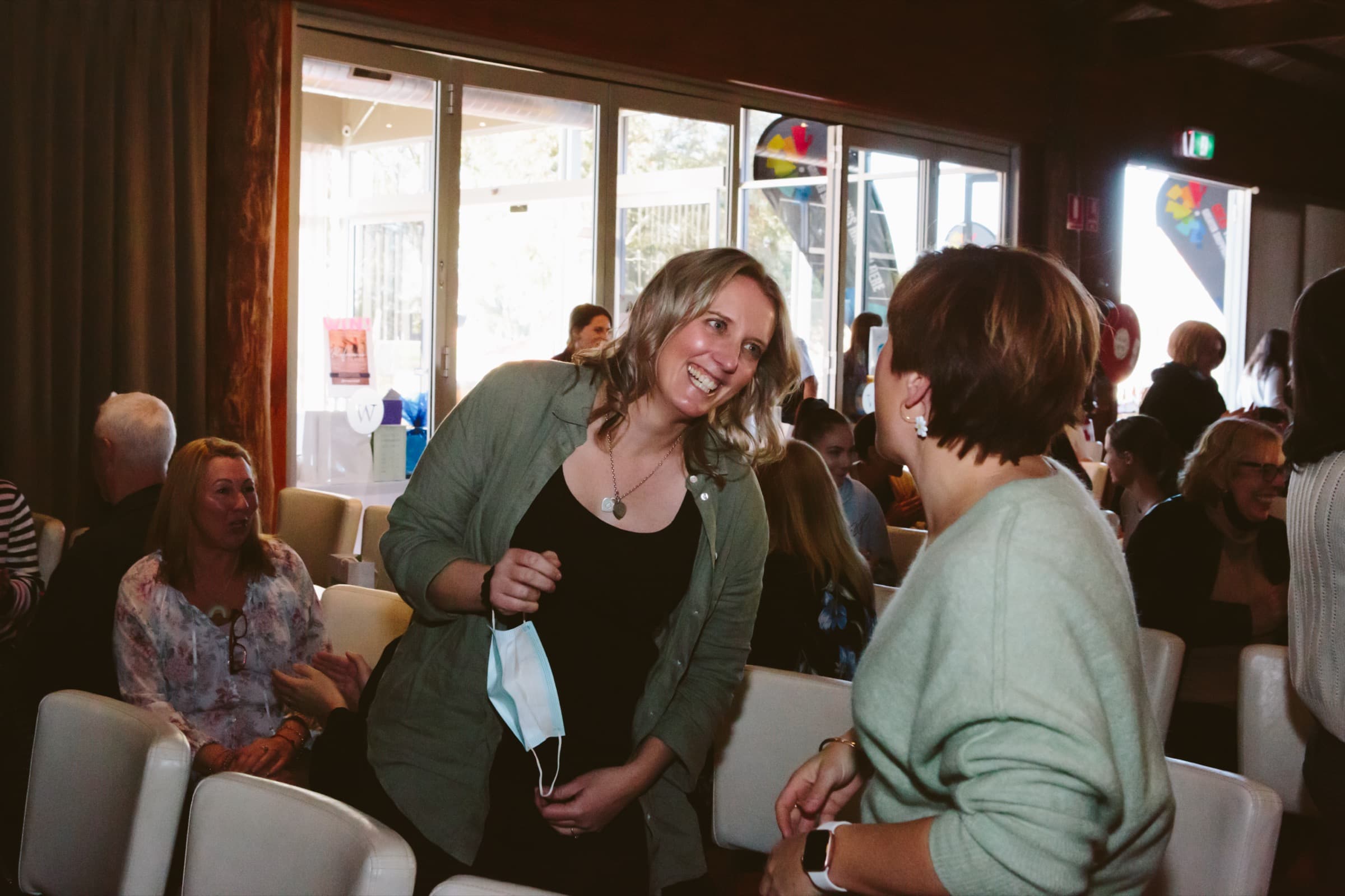 Two participants standing and laughing together mid-session at a Better Us Project workshop