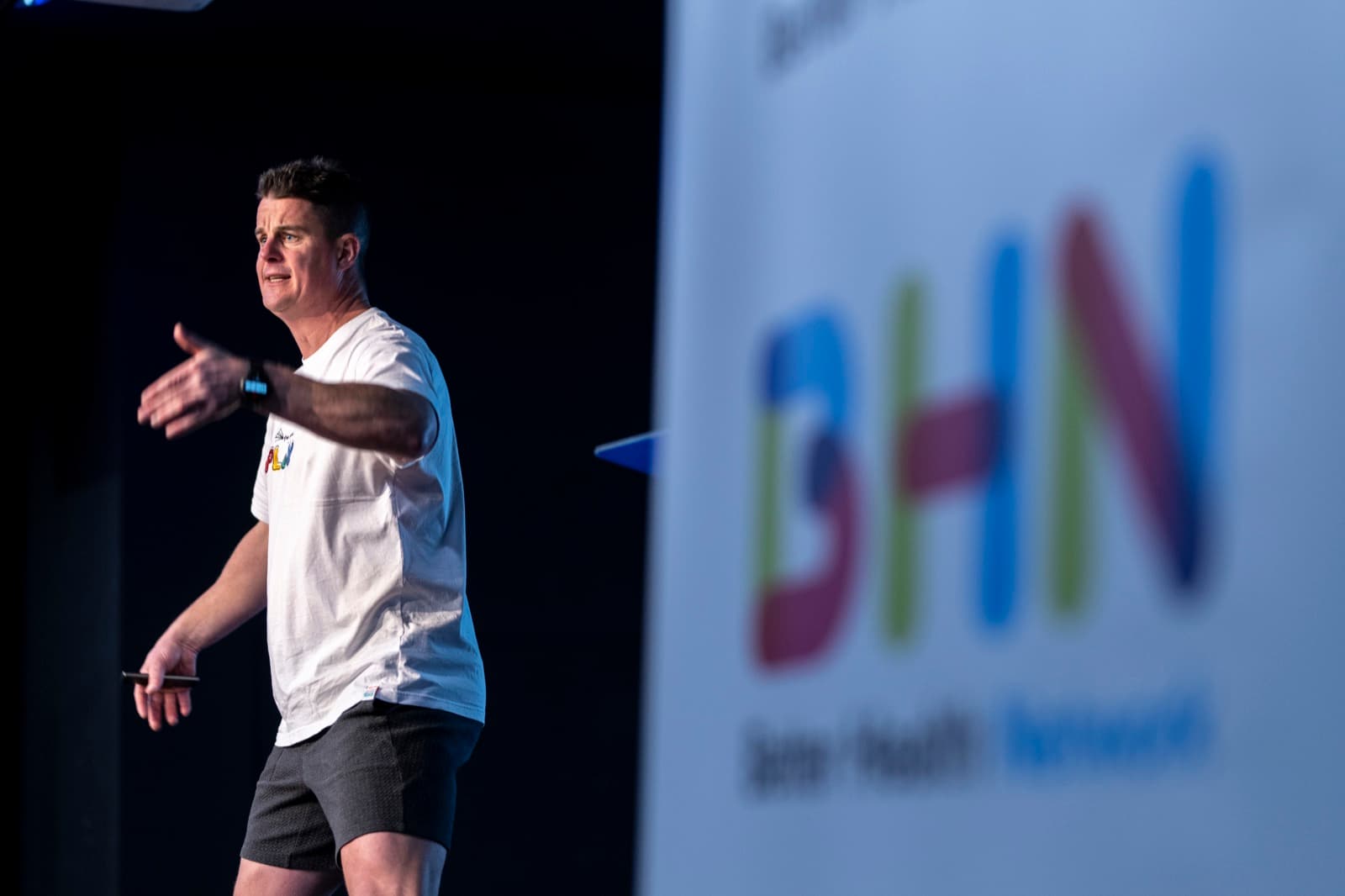A Better Us facilitator delivering a session on stage